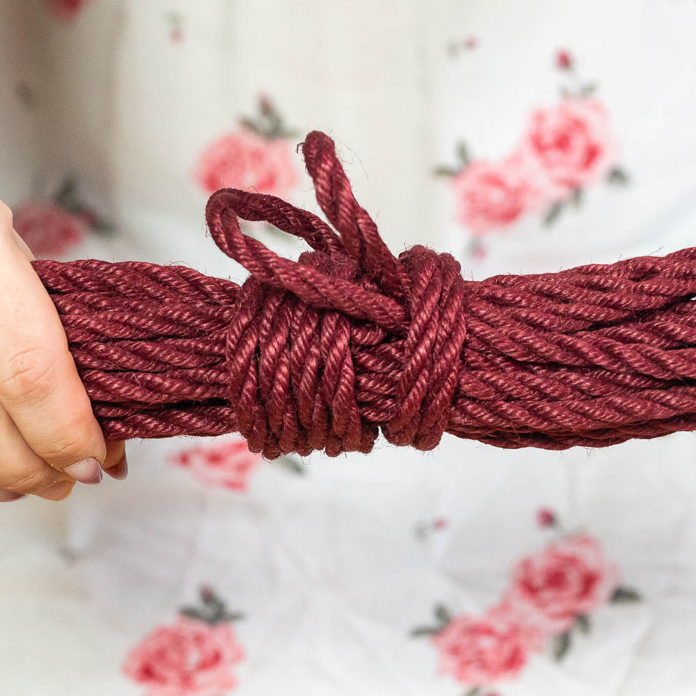 Final picture of a hanked shibari rope in red