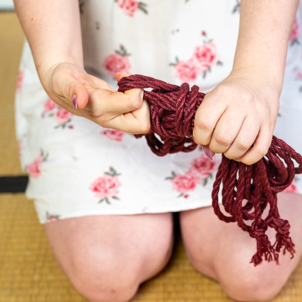 Artistic shot of a shibari rope coiled with precision for future tieing
