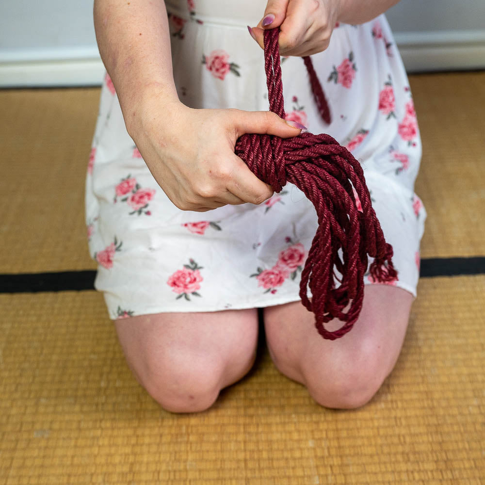 Artistic shot of a shibari rope coiled with precision for future tieing