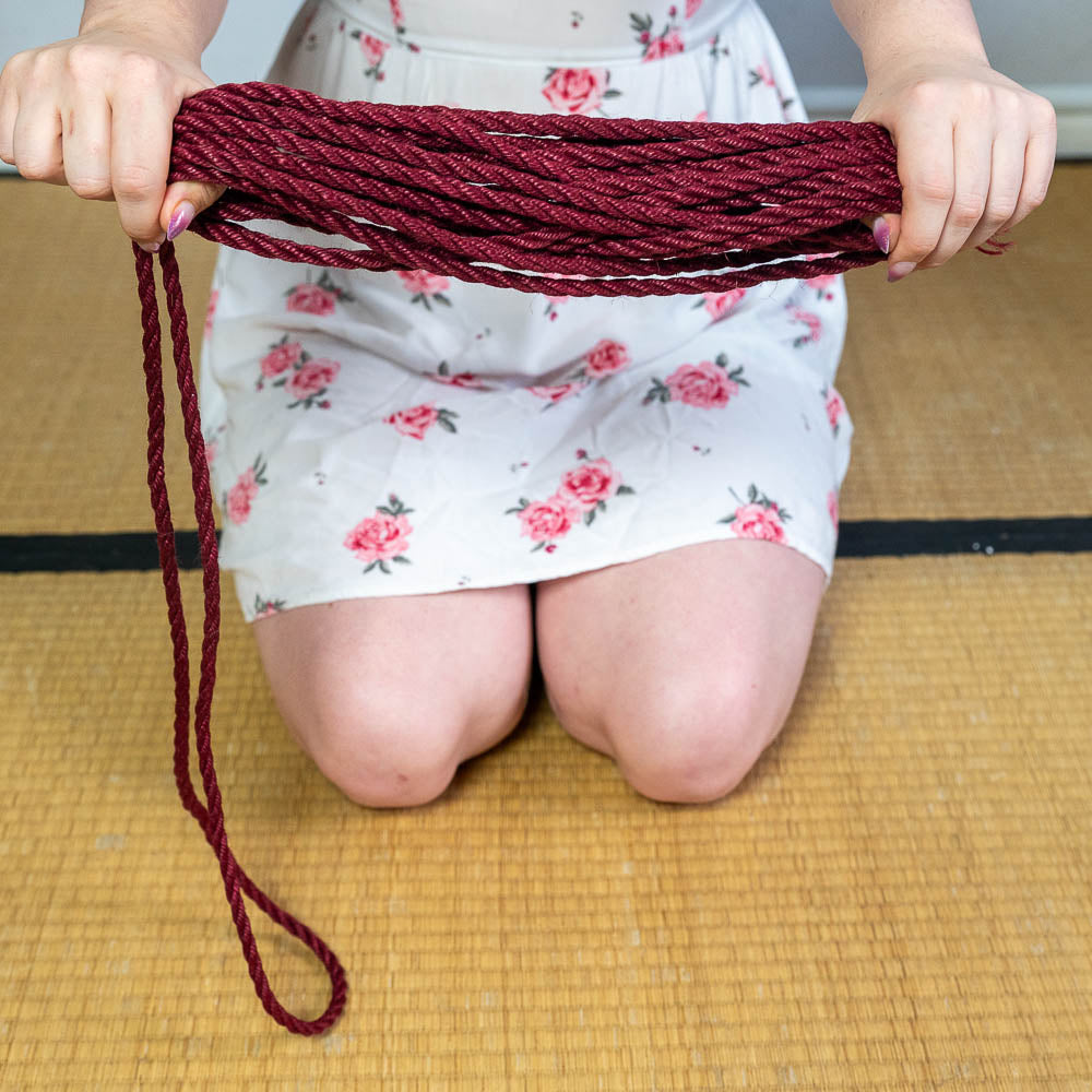 Coiled and folded shibari rope being prepared for future use