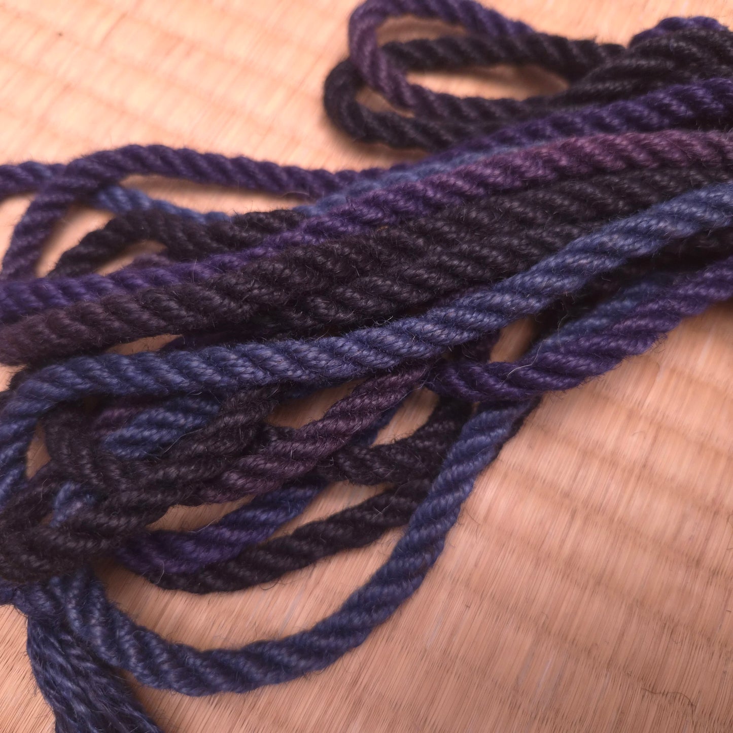 Blue and purple twisted rope on a tatami surface